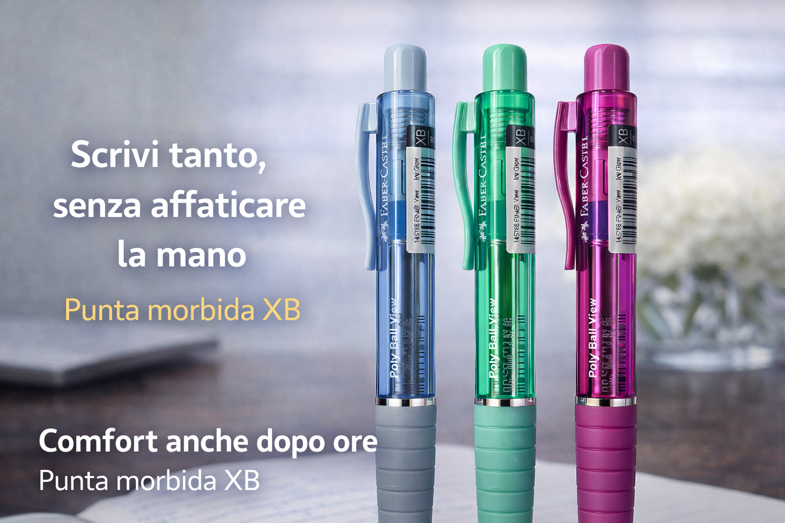 Tre penne a sfera Faber-Castell Poly Ball View dai colori azzurro, verde e fucsia con fusto trasparente e impugnatura ergonomica, fotografate su una scrivania con sfondo sfocato, ideali per una scrittura fluida e confortevole anche dopo ore.
